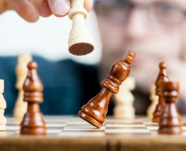 man holding chess piece