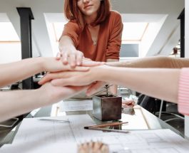 a group of people with their hands together