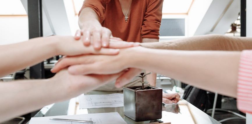 a group of people with their hands together