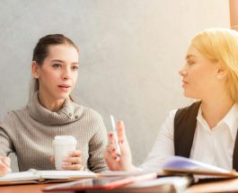 two women holding pen