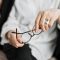 person holding brown framed eyeglasses