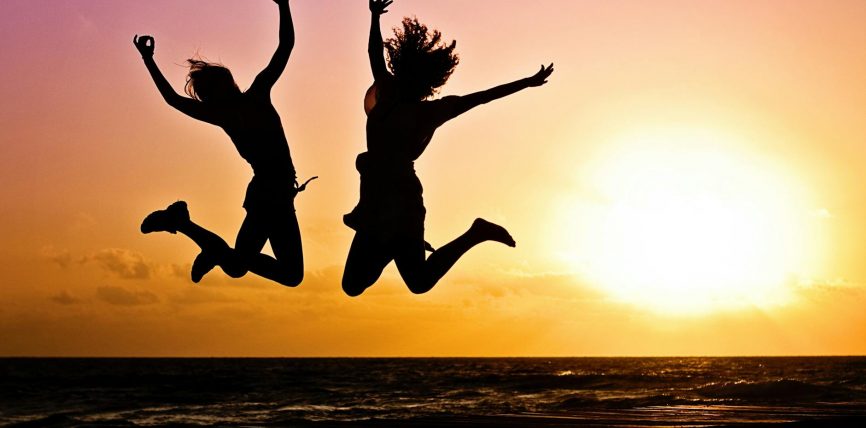 silhouette photography of jump shot of two persons