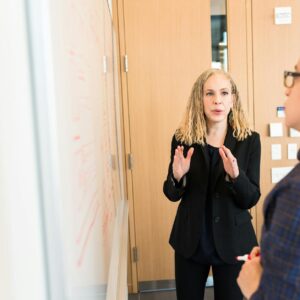 woman standing near whiteboard