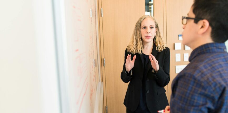 woman standing near whiteboard